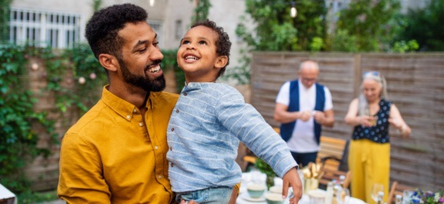 Father and son at backyard dinner