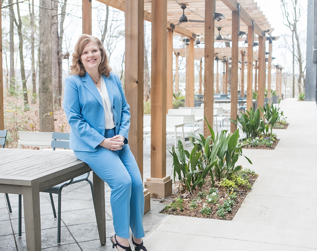 Female Protective employee standing in outdoor seating area
