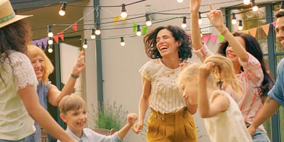 Multigenerational family dancing together at a backyard party