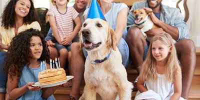 A family is gathered during a birthday party indicating a life change that may require a life insurance need. 