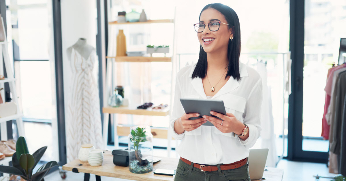 Young female store owner holding a tablet