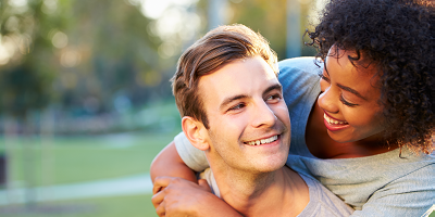 Woman in her 20s hugging a man in his 20s