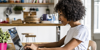 Young African American woman works on her laptop
