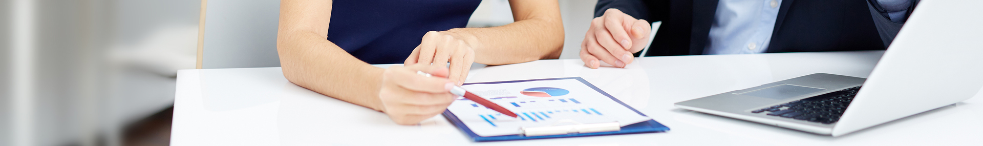 Professional woman and man review statistical figures together