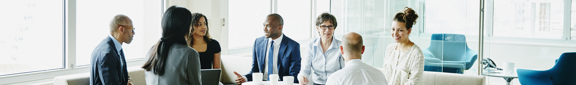 Diverse group of businesspeople sitting at conference table