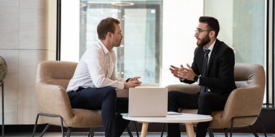 Two men having a conversation about commercial mortgage lending