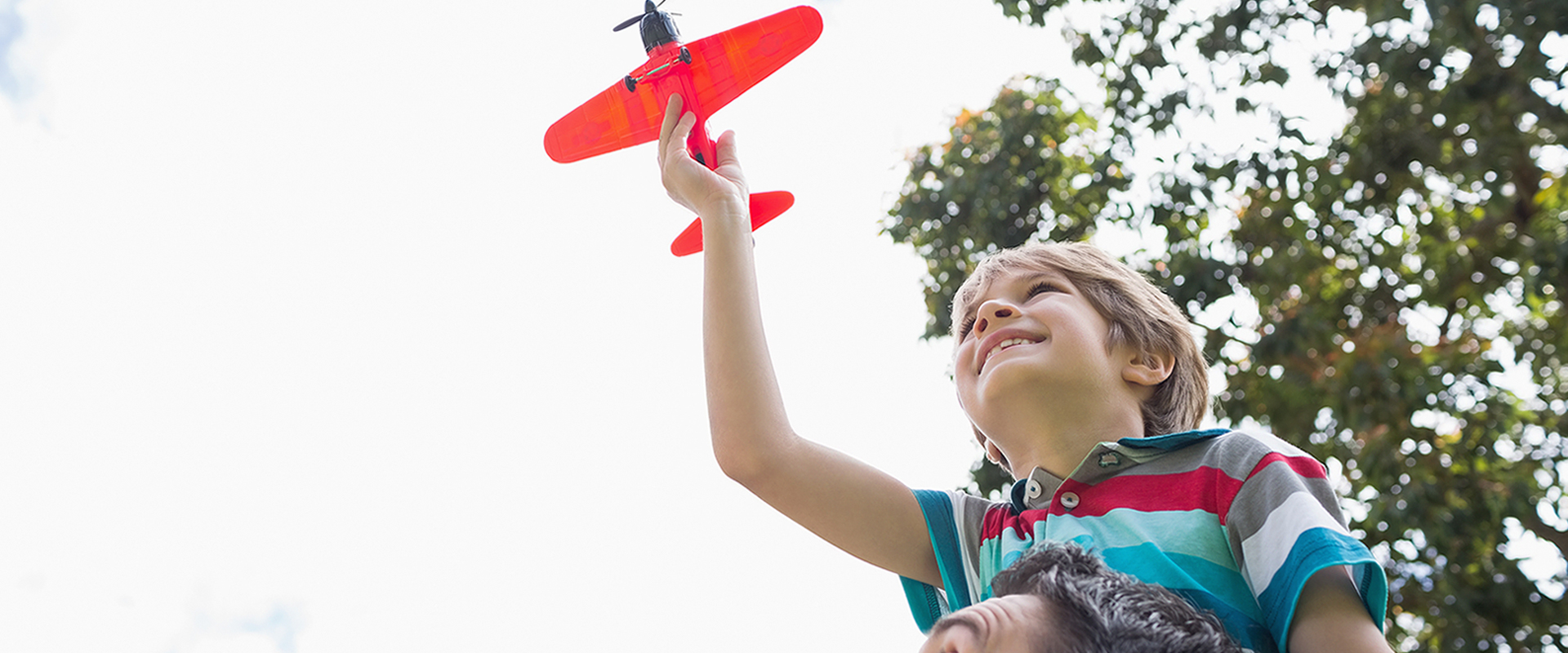 Boy playing with toy airplane