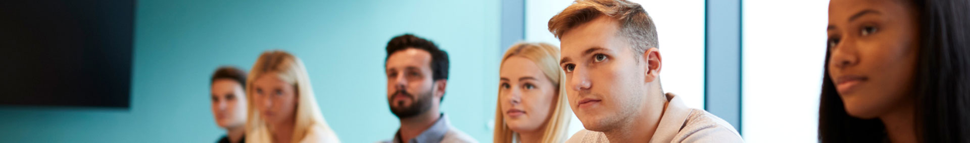 College students listen attentively around a table