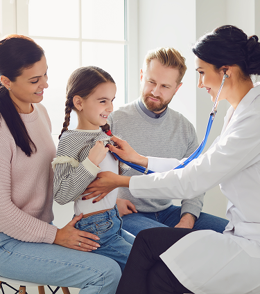 Mother holding child receiving medical care from a physician.