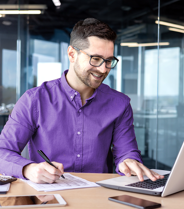 Employee sitting at desk reviewing his company 401(k) and pension.