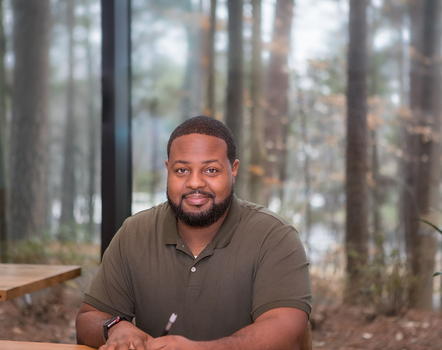 Male Protective employee sitting in conference room