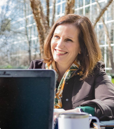 Protective's Executive Vice President and Chief Operations Officer, Cissy WiIliams, meets with a teammate outside of the Birmingham home office.