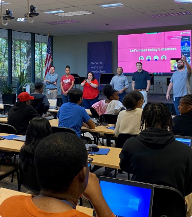 Students listen to a presentation during Protective's Artificial Intelligence Bootcamp.