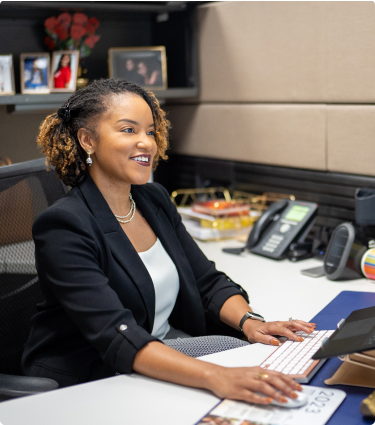 Business woman working at desk in office at Protective Life office.