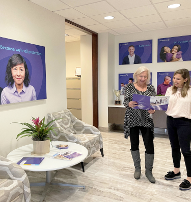 Protective teammates talking in our St. Louis office.