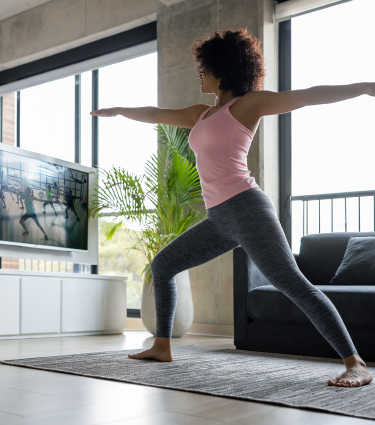 A virtual teammate doing yoga at home.