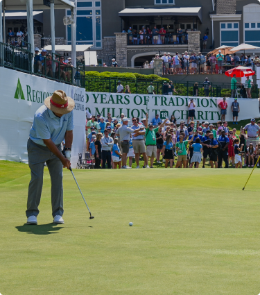 A player at the Regions Traditions Golf tournament lines up to take his shot on the green.