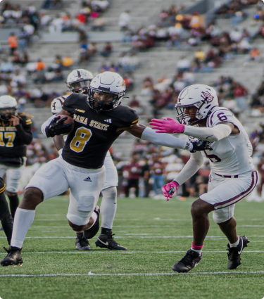 Football players on the field during the Magic City Classic.