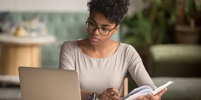 African-american woman looking at computer