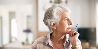 Older woman thoughtfully considering her claims questions.