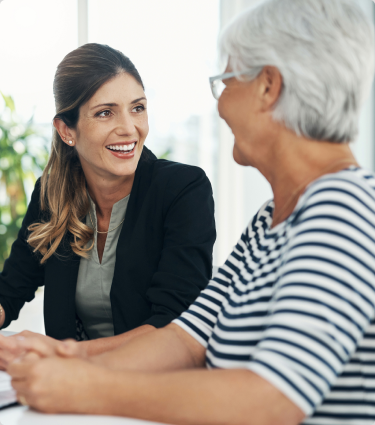 A smiling financial professional speaking to a client about Protective's life insurance solutions.