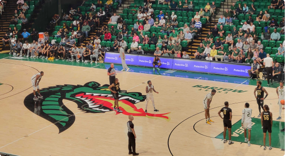 UAB basketball players on the court at a basketball game.