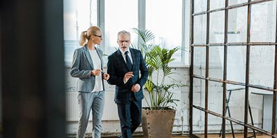 Man and woman walking in building