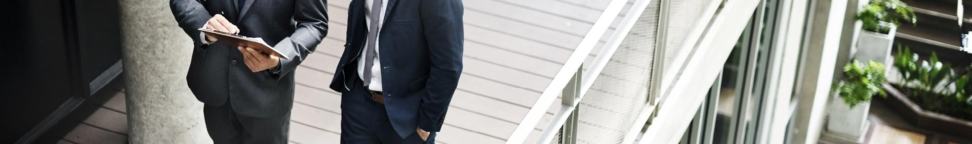 Two men walking outside an office building