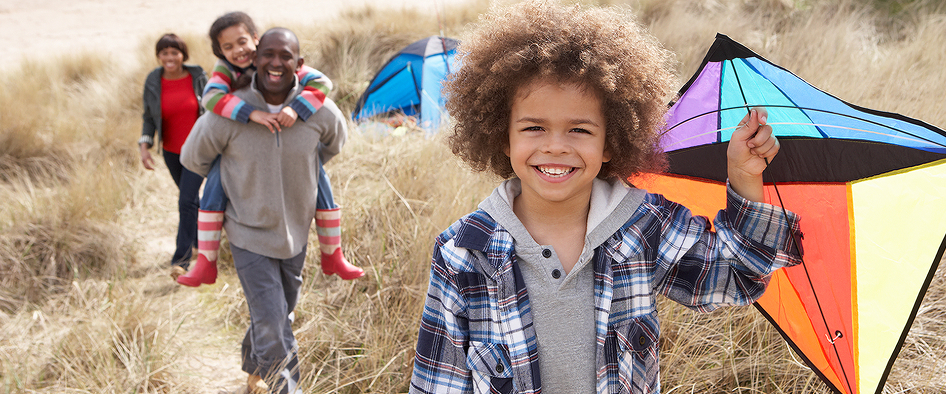 African-american family playing in field