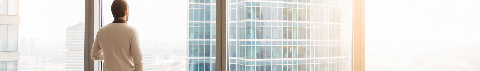 Businessman staring out of window