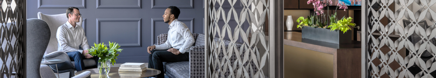 Two Protective teammates having a casual conversation in the office.