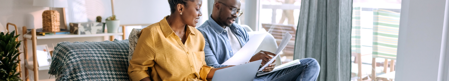A couple reviewing tax forms related to their Protective life insurance policy or annuity contract.