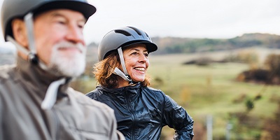 Senior couple in bike helmets enjoying the outdoors