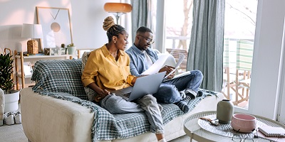 Young African American mom kisses her baby boy
