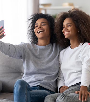 Mom and teenage daughter taking a selfie