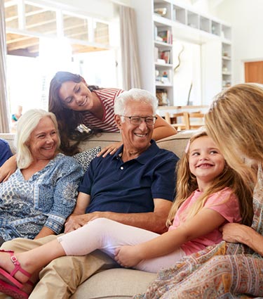 Multi-generational family sitting on a couch