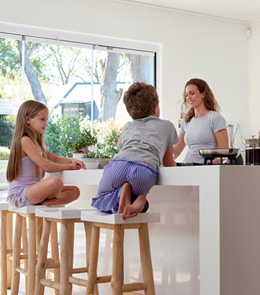 Husband and wife sitting on couch with young daughter