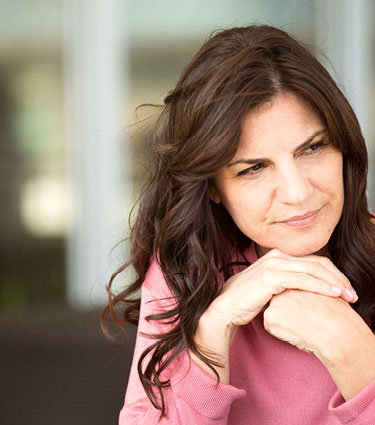 Woman resting chin on her hands looking into distance