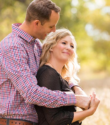 Young couple surrounded by moving boxes in new home