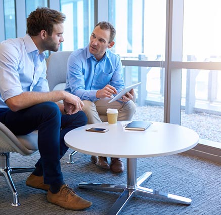 Two men discussing life insurance and looking at a tablet