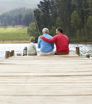 Senior man fishing with son and grandson