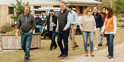 Protective employees walking on a tour of a farm