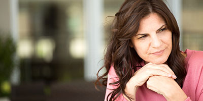 Woman looking pensive and wondering why her life insurance claim was denied.