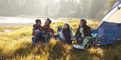 Family enjoying a camping trip thanks to their RV asset protection insurance.