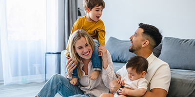 Husband and wife enjoying quality time with their two young children.