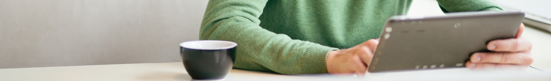 Man on computer tablet researching and choosing a life insurance company.