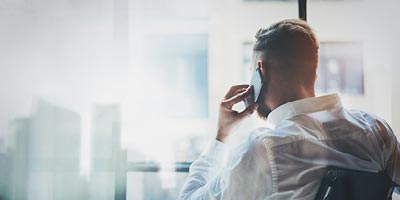 Man on phone by window wondering whether someone could purchase life insurance on him without his knowledge.