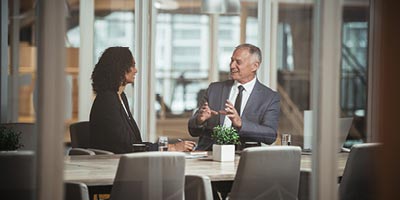Life insurance agent working with african-american woman to determine if a fast, no exam insurance policy is her best option