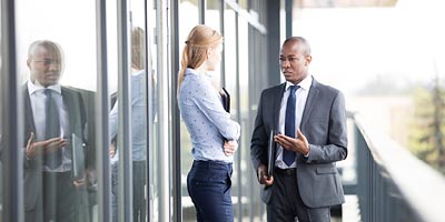 African-american advisor speaking to a woman about the benefits and differences in whole life insurance