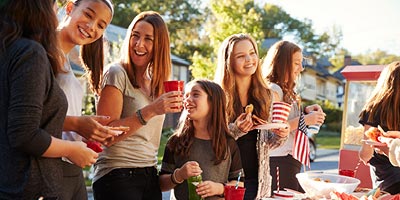 Happy family celebrates with food and drinks outside their RV